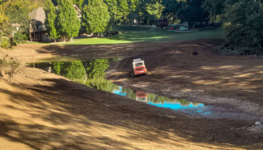 Erosion control around a retaining pond; surrounded by tree line
