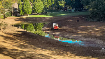 Erosion control around a retaining pond; surrounded by tree line
