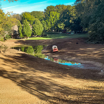 Erosion control around a retaining pond; surrounded by tree line
